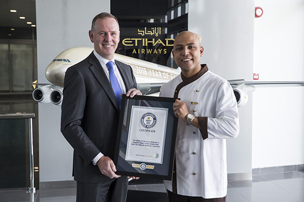 Tony Douglas, Group Chief Executive Officer, Etihad Aviation Group, congratulates Etihad Airways Inflight Chef, Sanjay Thakur