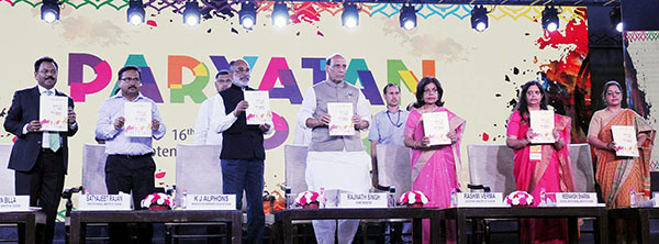 The Union Home Minister, Mr. Rajnath Singh releasing the event calendar at the inauguration of the countrywide Paryatan Parv. The Minister of State for Tourism (I/C), Mr. Alphons Kannanthanam, Secretary (MoT) Smt. Rashmi Verma, Director General (MoT) Mr. Satyajeet Rajan, Addl. D.G, Smt. Meenakshi Sharma, Joint Secretary (MoT) Mr. Suman Billa and other dignitaries are also seen.